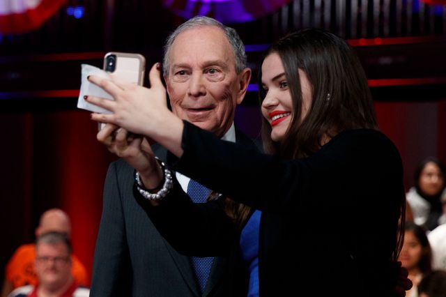 Democratic presidential candidate former New York City Mayor Mike Bloomberg poses for a photograph with an audience member during a break in a FOX News Channel Town Hall.
